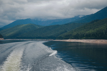 the concept of boating, relaxing at sea - splashes of blue water in the sea close-up