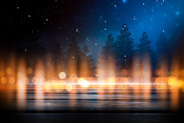Dark winter background. Wooden table top in the foreground, winter landscape with bokeh in the background