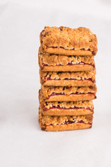Freshly baked homemade cookies with jam in stack. Balanced nutrition, proteins and carbohydrates, cereals