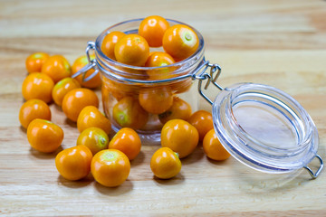 Cape Gooseberry in glass cup on wood table