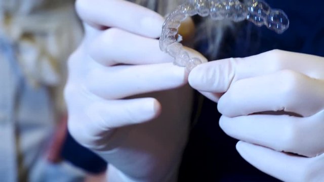 tight close-up of the maintenance of an invisalign aligner 