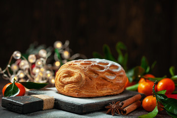 Apple strudel with tangerines and cinnamon sprinkled with sugar powder