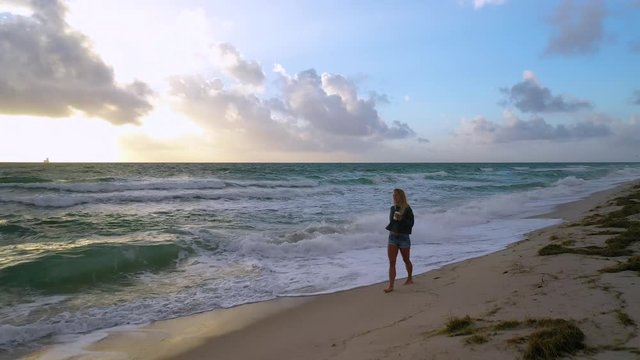 4K Morning Coffee Aerial Woman Walks on Beach Sunrise Calm Solitude