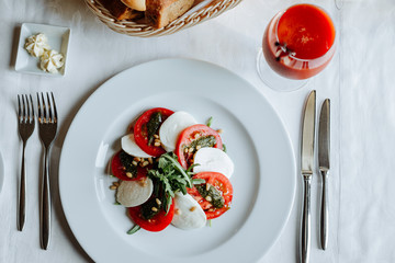 Caprese with arugula and pesto