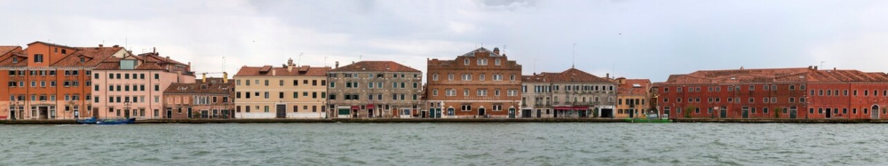 Fototapeta na wymiar View of the houses and promenade of the island of Giudecca in Venice