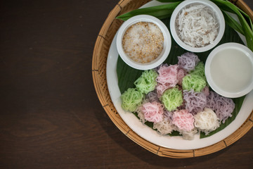 Colorful Thai Desserts (Ka-Nhom-Ray-Rai or Rang-rai ) Rice flour dumpling topped coconut milk and sugar mixed with sesame (Thailand traditional food)