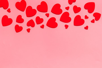 Valentine's Day design. Red hearts frame on pink background top-down copy space