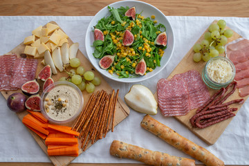 Table setting with salad and french baguette and ham
