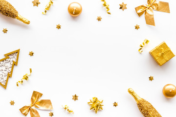New Year mockup in gold color. Champagne bottle, present box, decoration on white background top-down frame copy space