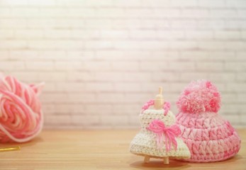Cute mini dress and hat. White and pink yarn Crochet on doll body. Creative craft work. DIY. Handmade. Copy space for any text design.