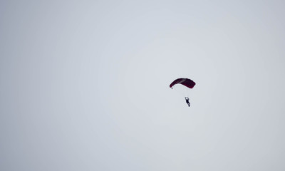 silhouette parachute stunt unfocused and blurry while gliding in the air