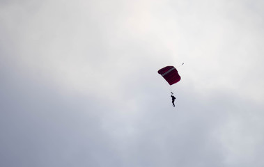 silhouette parachute stunt unfocused and blurry while gliding in the air
