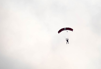 silhouette parachute stunt unfocused and blurry while gliding in the air