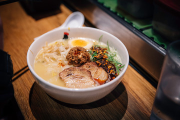A close up of Japanese ramen noodle soup at a restaurant on a table