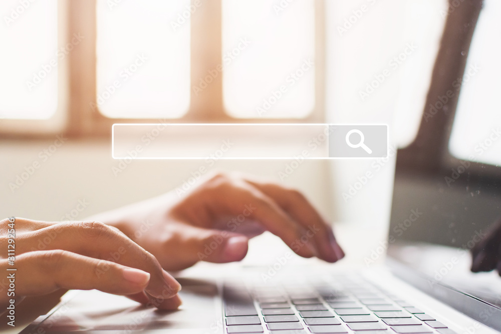 Wall mural searching information data on internet networking concept. hand of male typing text on laptop keyboa