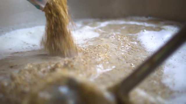 young guy cooking beer .