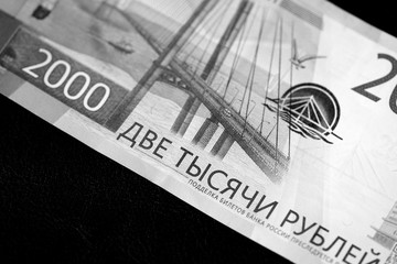 Two thousand rubles russian banknote on a dark background close up. Money background black and white