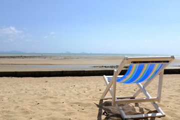 Fototapeta na wymiar Lounge Chair on a Beach Overlooking the Ocean