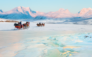 Cracking ice, frozen Cildir Lake coast at sunrise  Horses pulling sleigh in winter - Cildir Lake,...