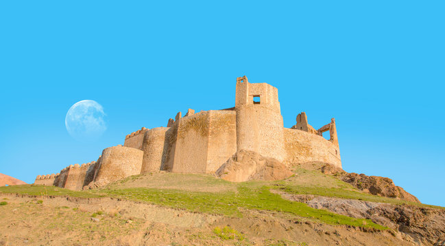 Hosap Castle with bright blue sky with full moon - Van, Turkey "Elements of this image furnished by NASA"