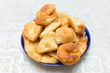Baursak traditional Mongolian food in a plate on the table