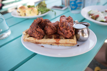 Close up of spicy chicken and waffle at brunch 