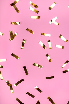 Gold Confetti On Pink Background. Flat Lay, Top View.