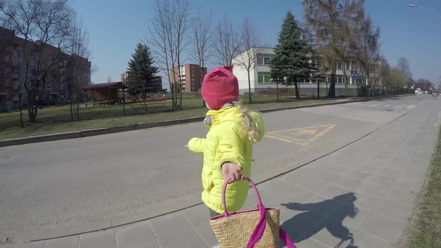 cute little model girl showing fashion with handbag. Toddler child simper