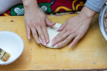 Fototapeta na wymiar woman prepares soft, juicy korean manti