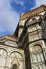 Fototapeta premium Detail of the facade of the Basilica di Santa Maria del Fiore (Florence Cathedral or Cathedral of Saint Mary of the flower), the main church of Florence, Italy. Bottom view.