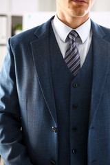 Male arm in blue suit set tie closeup