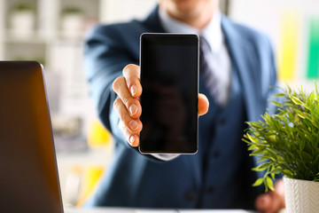 Male arm in suit show in camera phone display