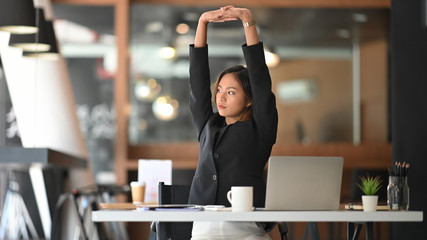 Businesswoman relaxing at comfortable in office hands behind head, happy woman resting in office...