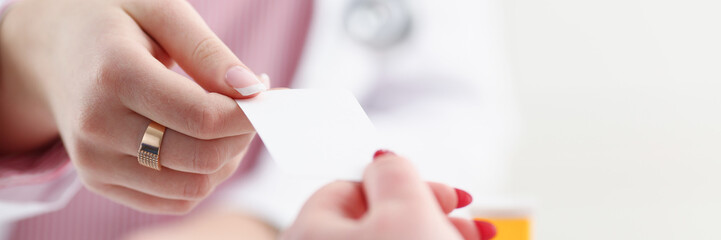 Female physician hand give white blank