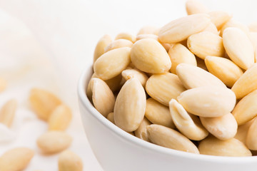 Bowl of almonds on a white background
