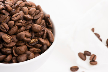 Bowl of caffee beans on a white background
