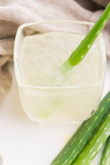 Glassware with fresh aloe vera juice and leaves