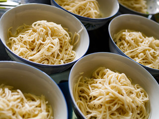 Close up of Asian Chinese wheat noodles in porcelain bowls