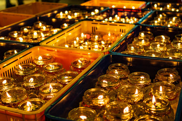 Fototapeta na wymiar Oil lamps in a Buddhist temple in Singapore during Vesak Day / Buddha Day celebrations