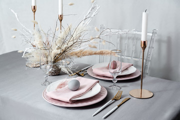 Setting Easter table with candles