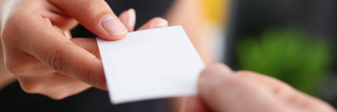 businesswoman give her business card to her new partner closeup