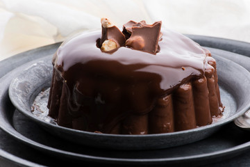 Chocolate pudding with chocolate dressing on a plate