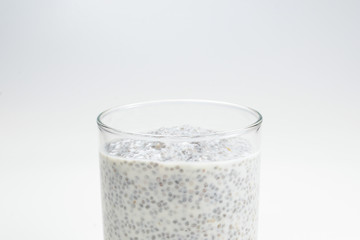 Chia pudding  in glass on a white background. Space for text or design.