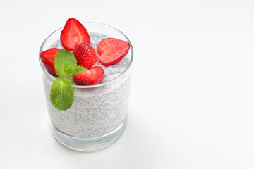 Chia pudding with strawberry and mint on a white background. Space for text or design.