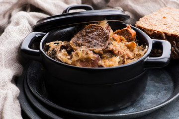 Traditional polish sauerkraut (bigos) with mushrooms and plums for christmas