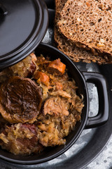 Traditional polish sauerkraut (bigos) with mushrooms and plums for christmas