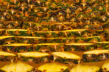 Pineapple juicy yellow slices background. Top view.