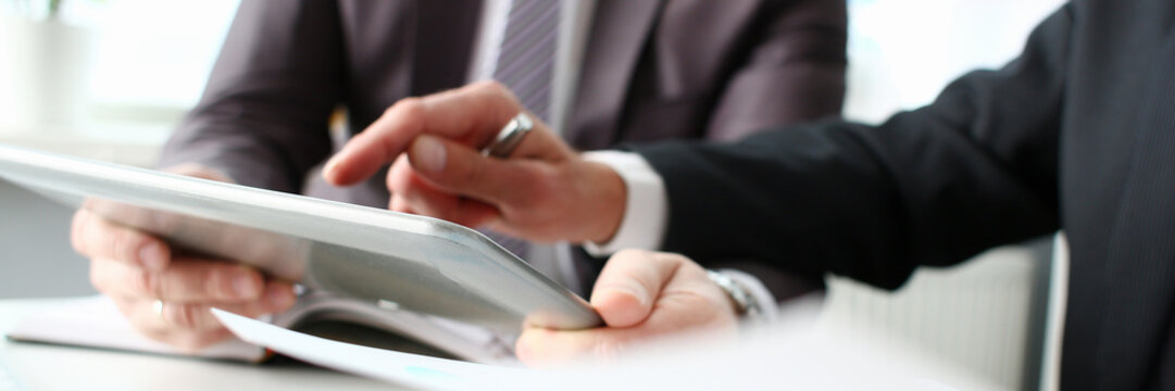 Two businessman are looking and