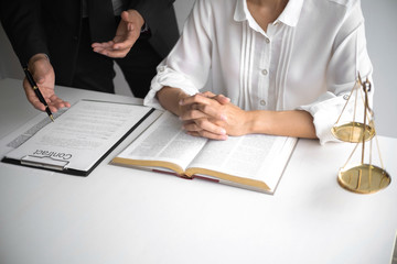 Lawyer and client with legal contract signing in law firm.