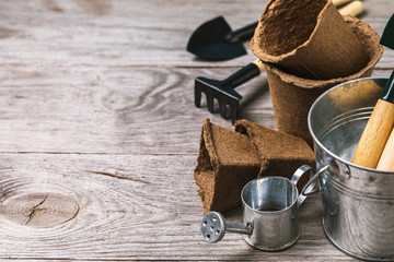 Various garden tools on a wooden table with copy space